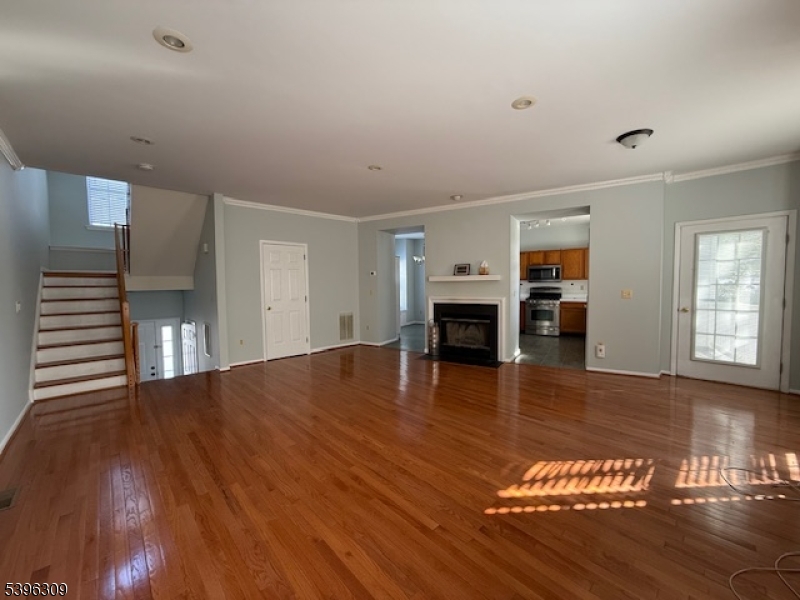 404 Brookview Court Whippany, NJ 07981 - Photo 23 of 29 a view of empty room with wooden floor and fireplace