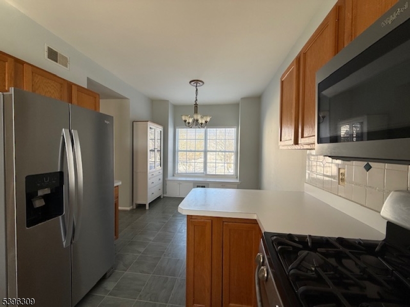 404 Brookview Court Whippany, NJ 07981 - Photo 25 of 29 a kitchen with stainless steel appliances granite countertop a refrigerator and a stove top oven
