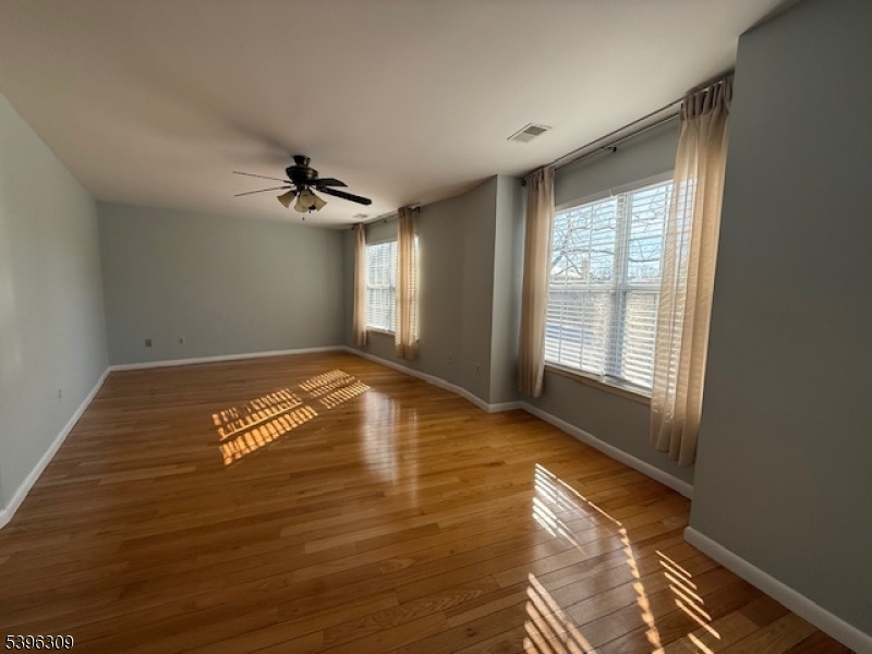 404 Brookview Court Whippany, NJ 07981 - Photo 27 of 29 a view of empty room with wooden floor and fan