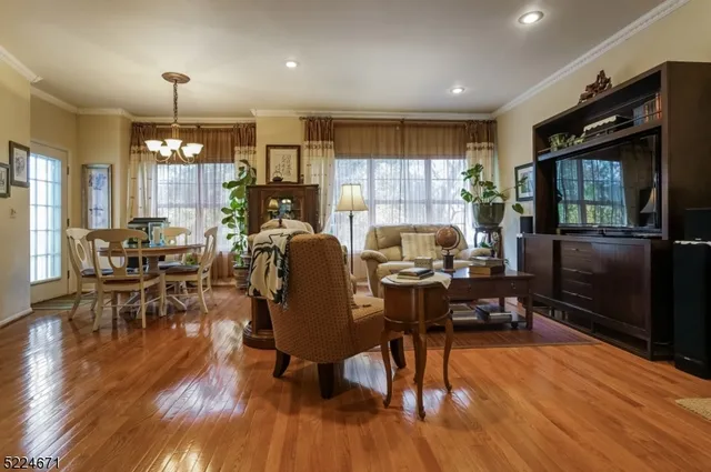 a living room with furniture flat screen tv and wooden floor