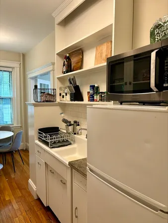 a kitchen with stainless steel appliances a stove a microwave and a refrigerator