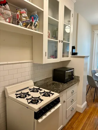 a white stove top oven sitting inside of a kitchen