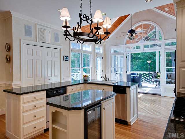 445 Swans Mill Crossing Raleigh, NC 27614 - Photo 3 of 17 Beautiful Chefs Kitchen with soaring beadborad ceiling in Breakfast Room and french doors leading to stunning screened in porch. SS Appliances, wine fridge, granite counters...etc.
