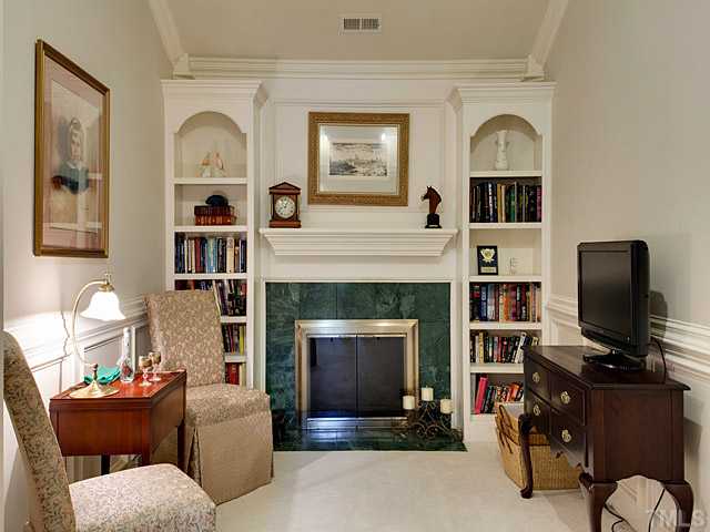 445 Swans Mill Crossing Raleigh, NC 27614 - Photo 8 of 17 Cozy Master sitting room with fireplace, built-ins and vaulted ceiling.
