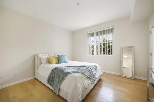 a bedroom with a bed and a window