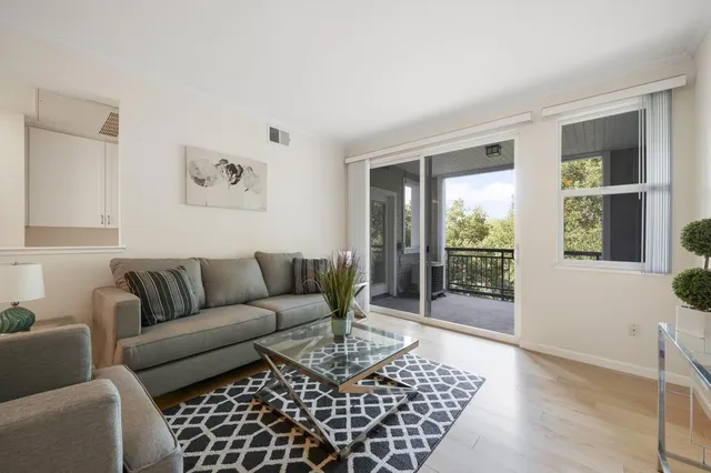 a living room with furniture and a floor to ceiling window