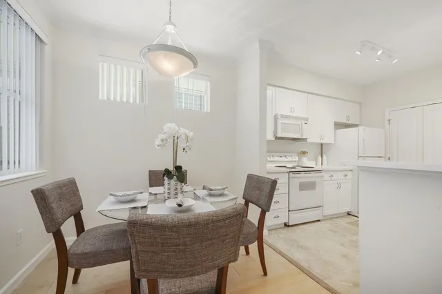 a kitchen with white cabinets and white appliances