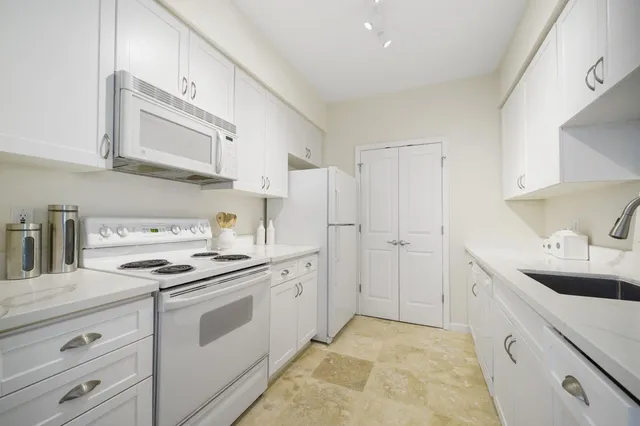 a kitchen with sink and cabinets