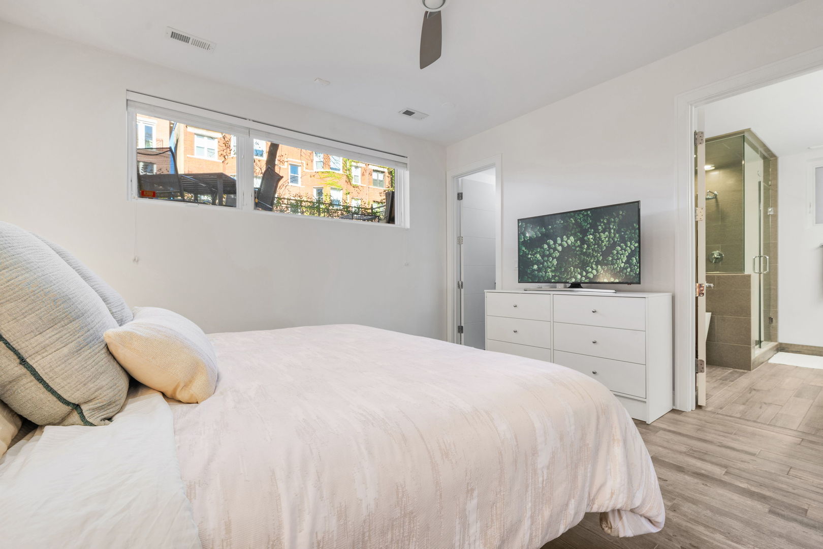 933 West George Street, Unit 1N Chicago, IL 60657 - Photo 19 of 30 a bedroom with a bed and a flat screen tv