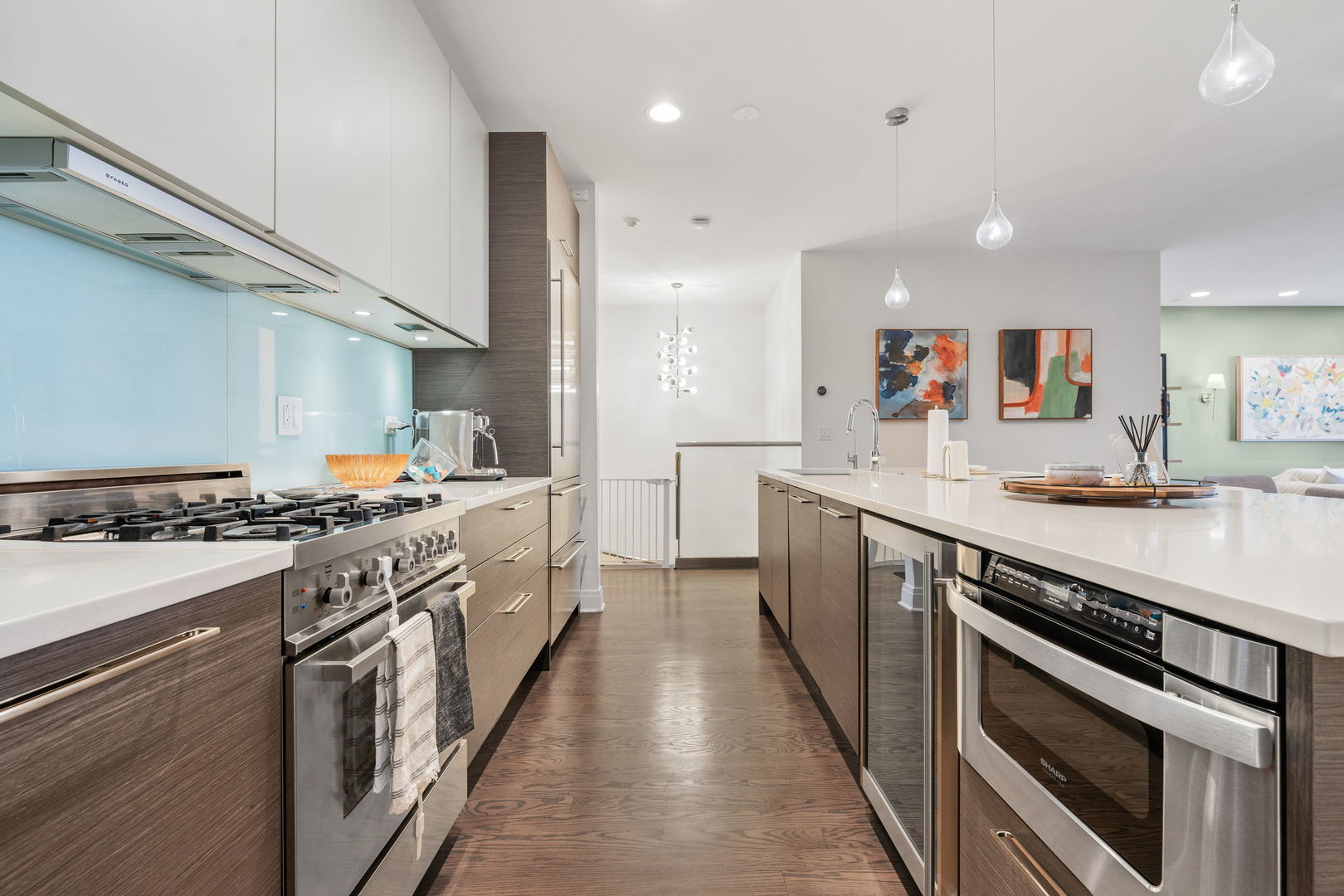 933 West George Street, Unit 1N Chicago, IL 60657 - Photo 7 of 30 a large kitchen with stainless steel appliances granite countertop a lot of counter space and wooden floor