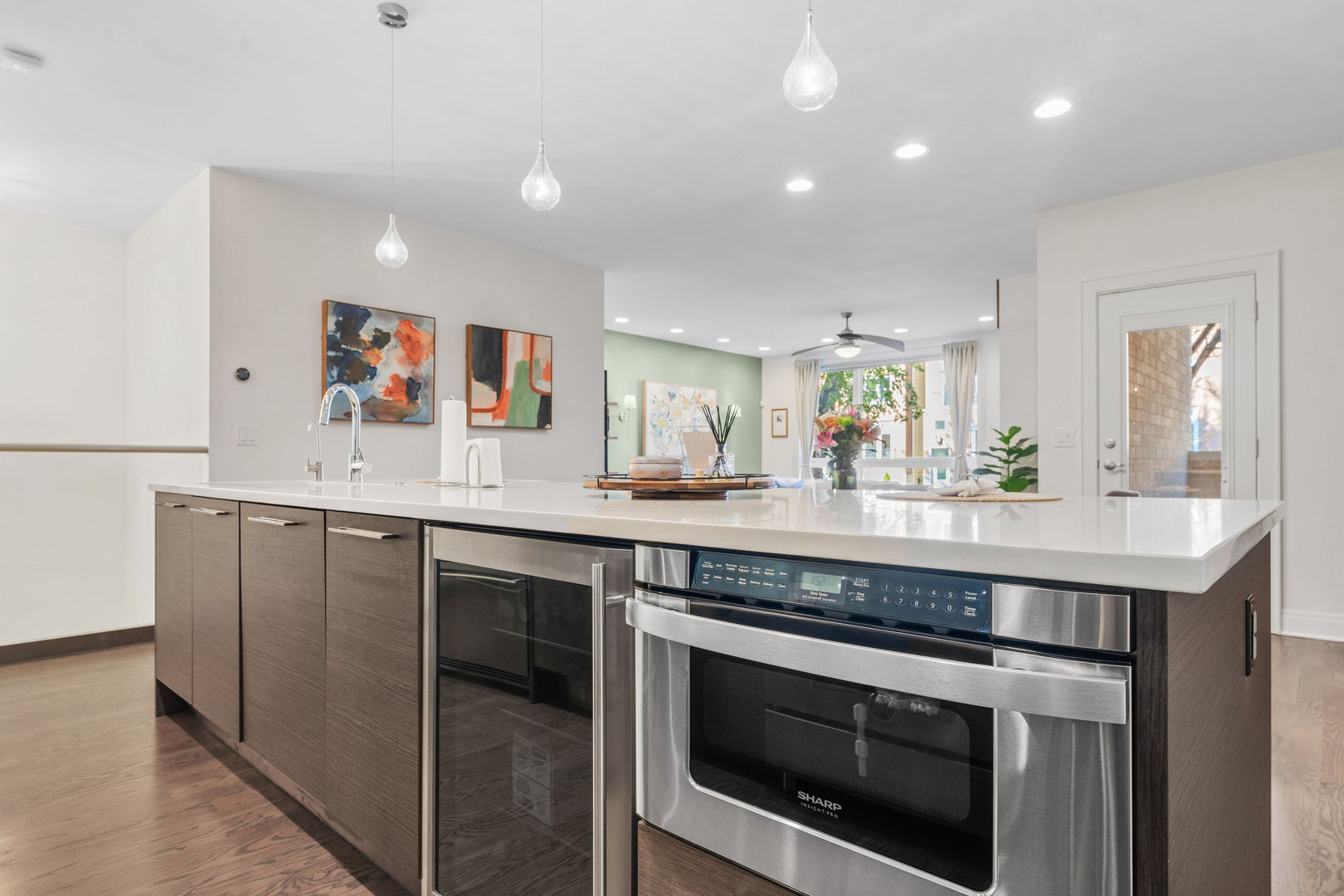 933 West George Street, Unit 1N Chicago, IL 60657 - Photo 9 of 30 a kitchen with a sink and a stove top oven with wooden floor