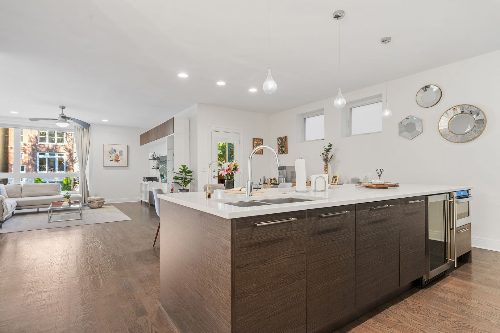 933 West George Street, Unit 1N Chicago, IL 60657 - Photo 10 of 30 a large white kitchen with a sink and dishwasher with chairs