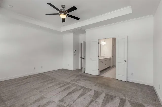 an empty room with fan and a ceiling fan