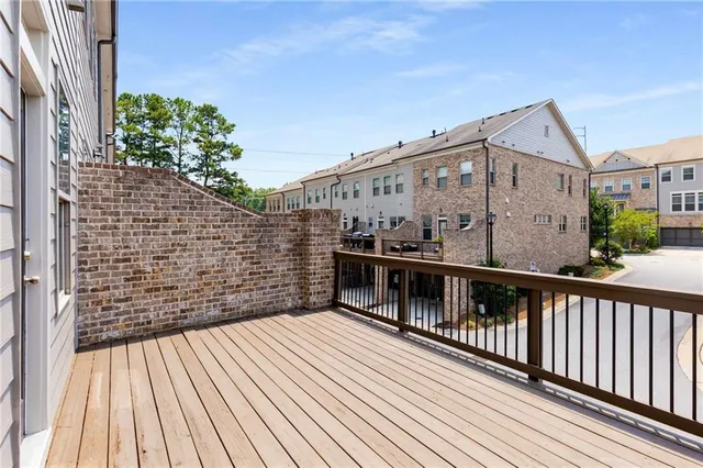 a balcony view with two chairs and wooden floor