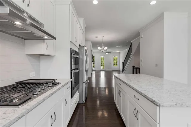 a kitchen with stainless steel appliances granite countertop a stove and a sink