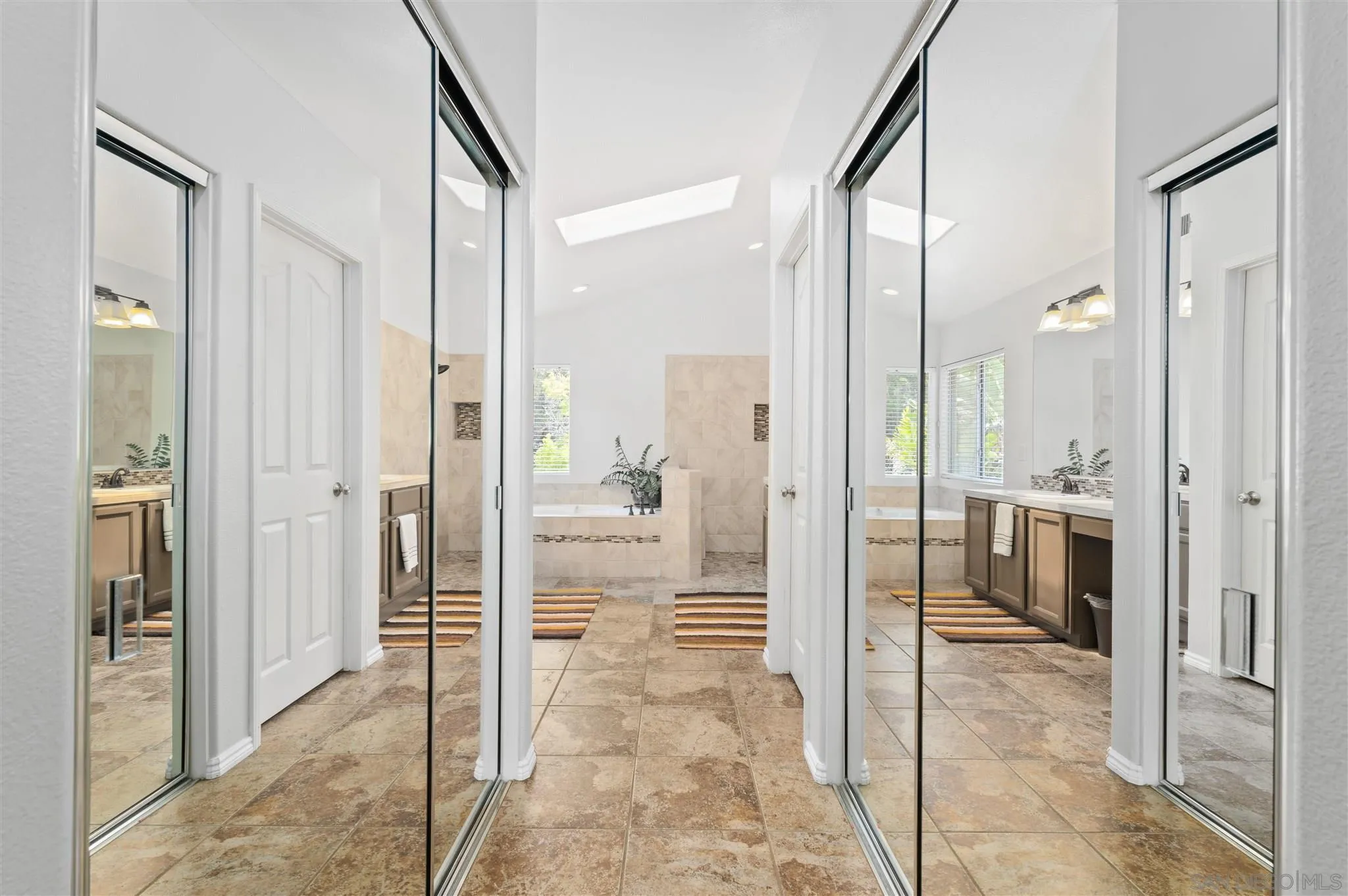 798 Windridge Circle San Marcos, CA 92078 - Photo 13 of 31 a bathroom with a glass shower door and a glass door