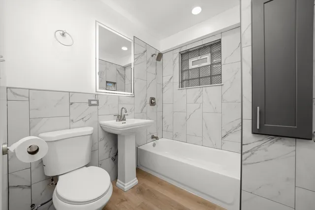 a bathroom with a sink toilet and shower