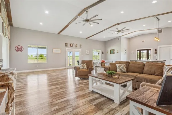 a living room with furniture and wooden floor
