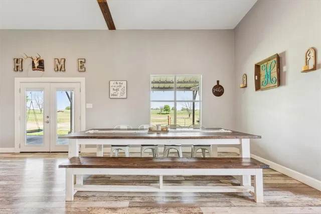 a view of a hallway with wooden floor and a large window