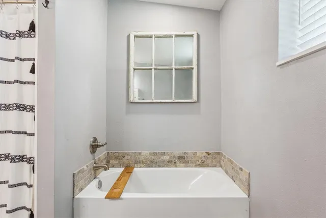 a view of walk in closet with clothes