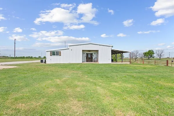 a view of an house with backyard space and garden