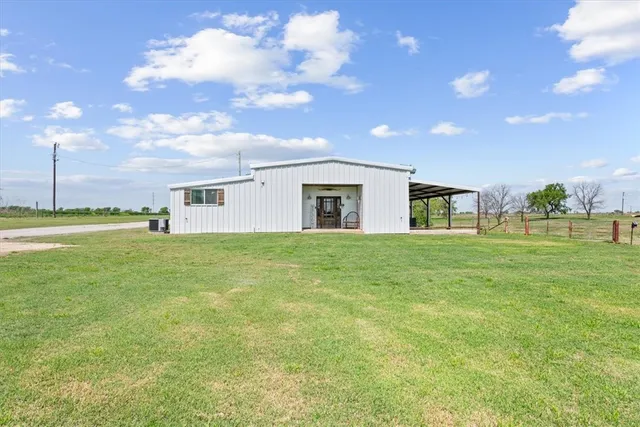 a view of an house with backyard space and garden