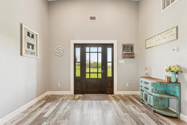 a view of an entryway with wooden floor