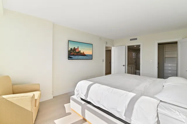 a bedroom with a bed and a couch