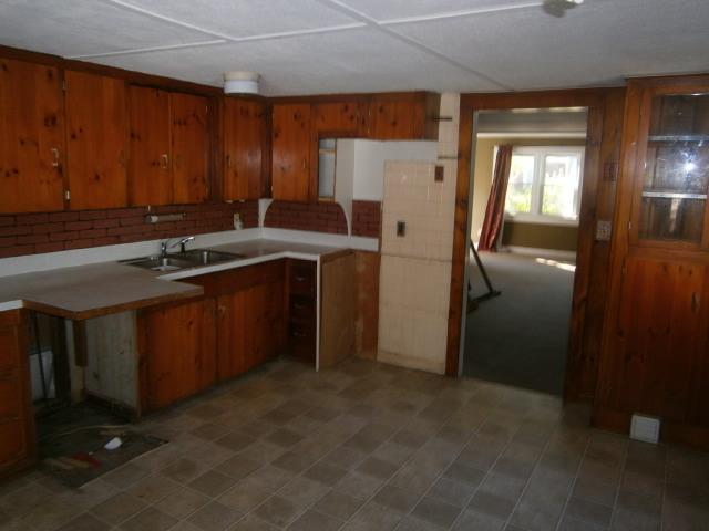 22 Brookshire Road Hyannis, MA 02601 - Photo 3 of 10 a kitchen with stainless steel appliances granite countertop a refrigerator a sink a stove and dishwasher with wooden cabinets