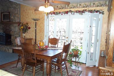 1090 Rutherford Road Rutherford, CA 94558 - Photo 3 of 10 a view of a dining room with furniture and chandelier