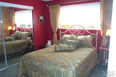 1090 Rutherford Road Rutherford, CA 94558 - Photo 6 of 10 a large white bed sitting in a bedroom next to a window