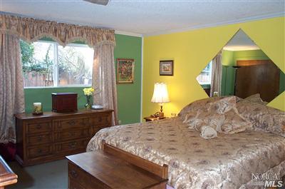 1090 Rutherford Road Rutherford, CA 94558 - Photo 7 of 10 a bedroom with a bed and a dresser