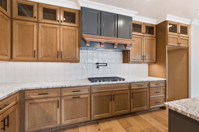 a kitchen with stainless steel appliances granite countertop a stove and a cabinets