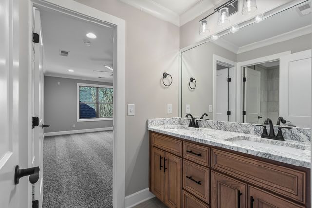 a bathroom with a granite countertop sink a mirror and a shower