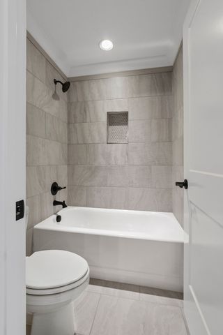 a bathroom with a bathtub and a toilet