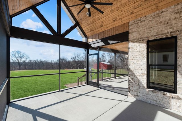a view of a porch with a floor to ceiling window and an outdoor view