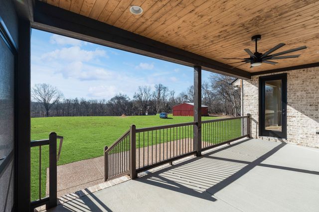a view of a porch with wooden floor and outdoor seating