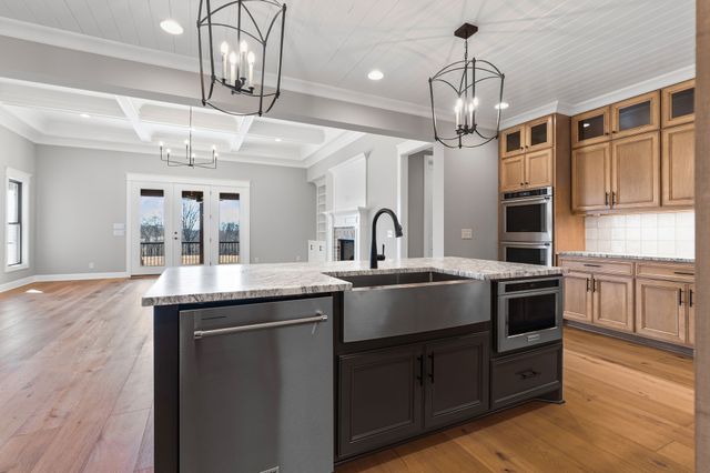 a kitchen with stainless steel appliances granite countertop a sink and stove