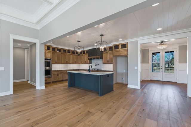 a kitchen with stainless steel appliances kitchen island wooden cabinets and granite counter tops