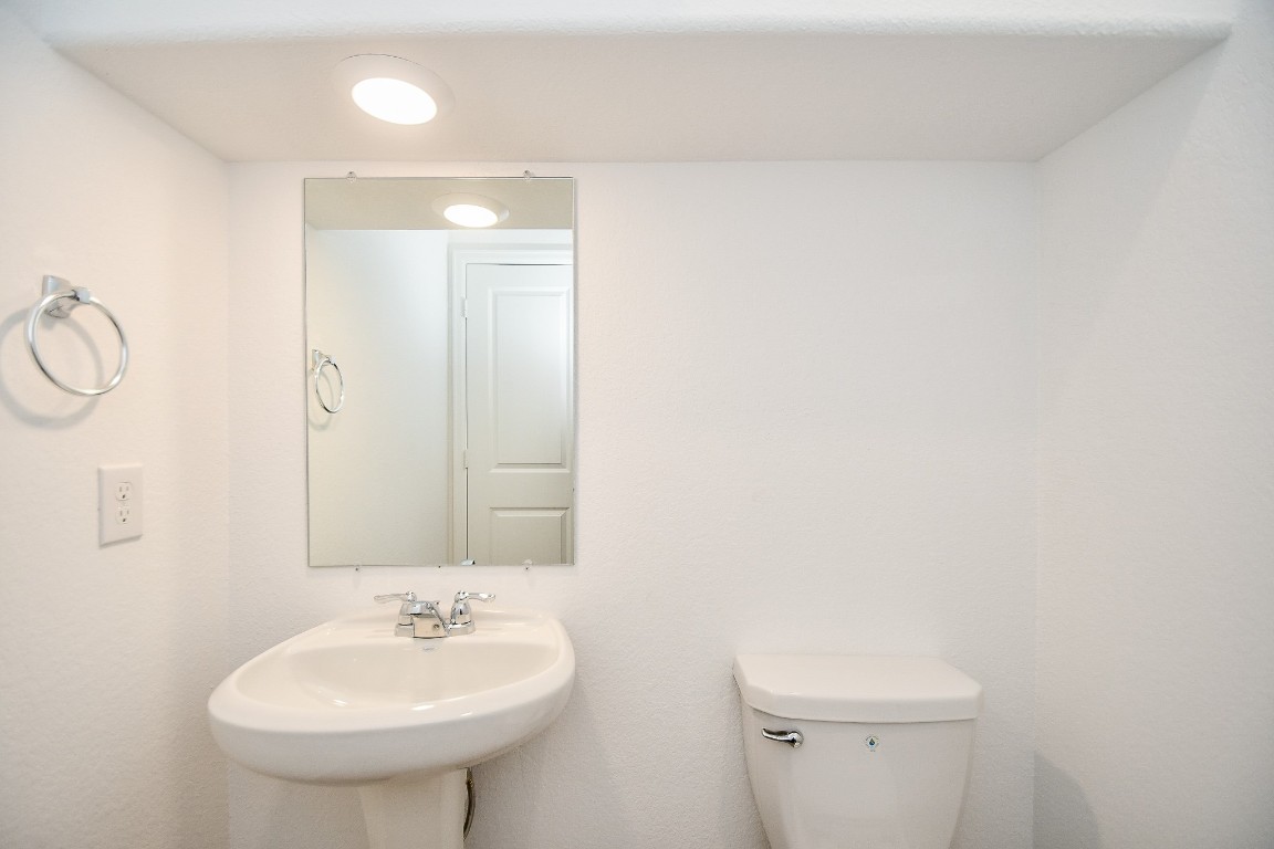 5240 Pine Pass Drive Rosenberg, TX 77469 - Photo 12 of 32 a bathroom with a sink a toilet and a mirror