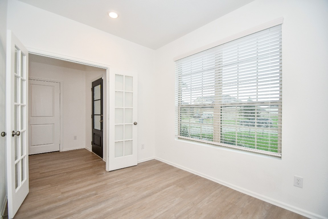 5240 Pine Pass Drive Rosenberg, TX 77469 - Photo 15 of 32 a view of an empty room with wooden floor and a window