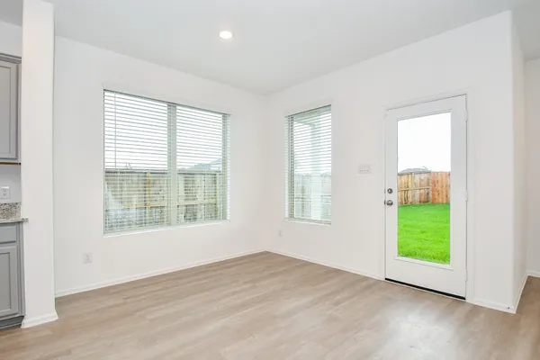 a view of kitchen with stainless steel appliances refrigerator oven stove microwave and cabinets