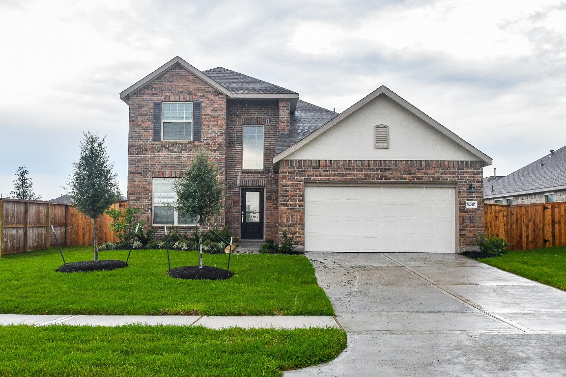 5240 Pine Pass Drive Rosenberg, TX 77469 - Photo 2 of 32 a front view of a house with a yard and garage