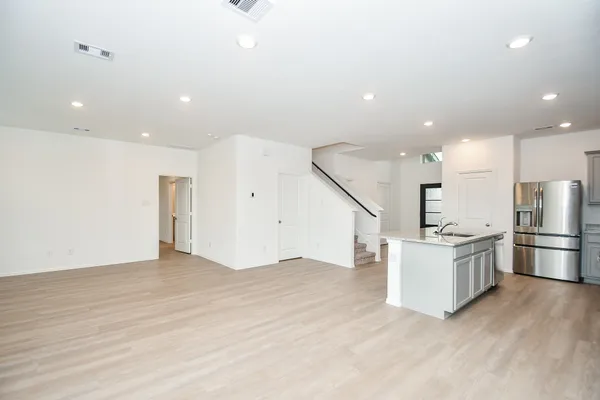 a view of kitchen with kitchen island and stainless steel appliances