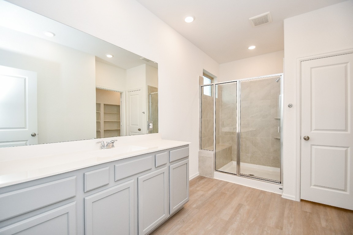 5240 Pine Pass Drive Rosenberg, TX 77469 - Photo 27 of 32 a bathroom with a shower sink and mirror