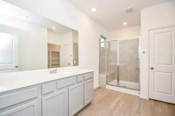 a view of walk in closet with empty racks