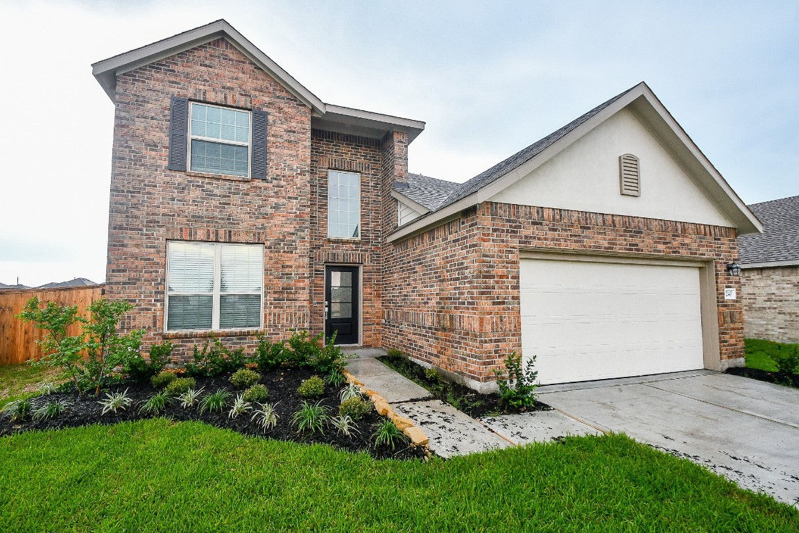 5240 Pine Pass Drive Rosenberg, TX 77469 - Photo 3 of 32 a front view of a house with a garden and plants