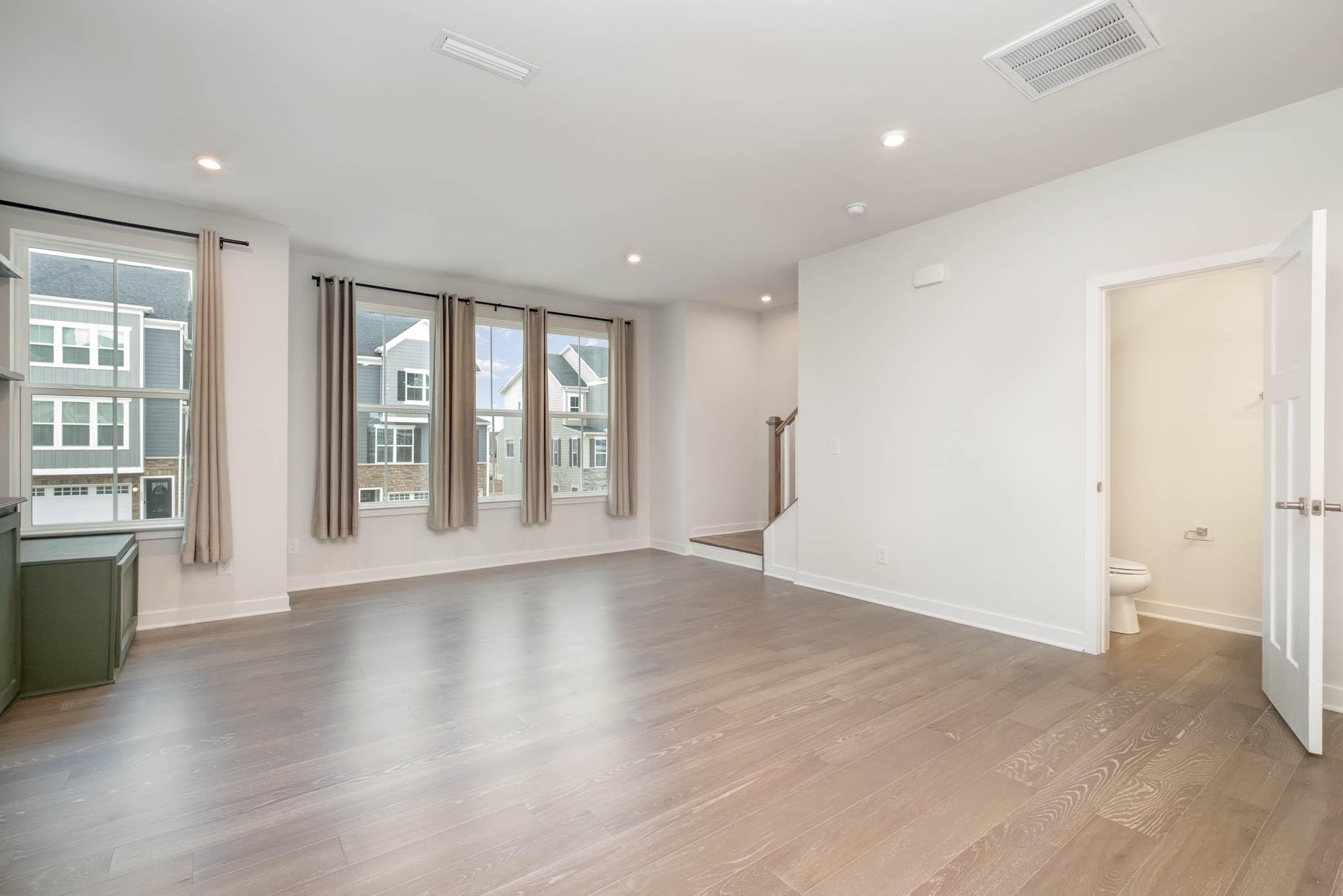 659 Crudent Road Tega Cay, SC 29708 - Photo 16 of 30 an empty room with wooden floor and windows