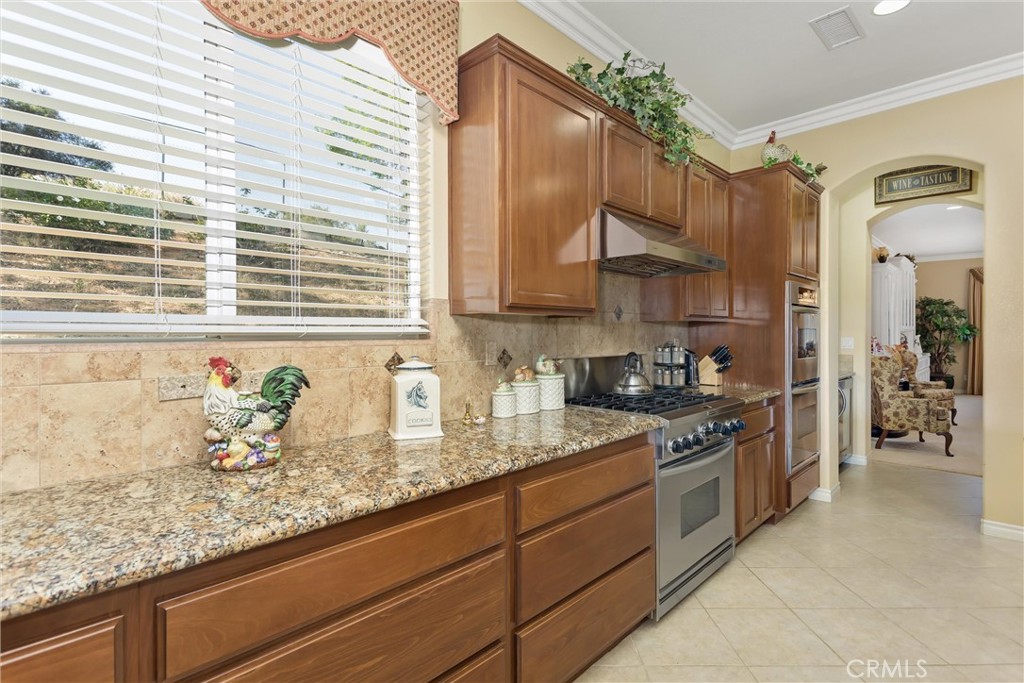 9841 Kehl Canyon Road Beaumont, CA 92223 - Photo 15 of 57 a kitchen with stainless steel appliances granite countertop a sink and a stove