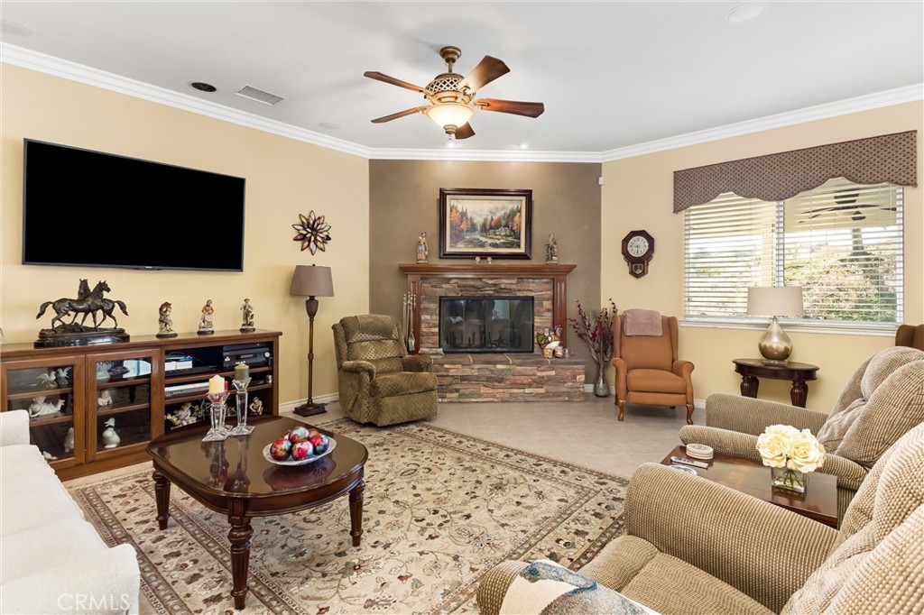 9841 Kehl Canyon Road Beaumont, CA 92223 - Photo 20 of 57 a living room with furniture and a flat screen tv